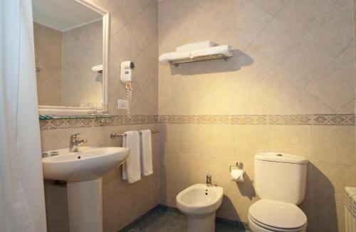 a bathroom with a white toilet and a sink at Sierra Nevada in El Calafate