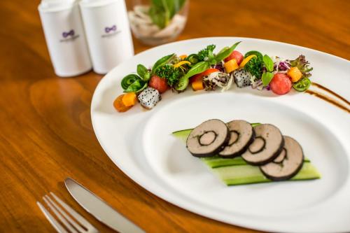 a plate of food with vegetables on a table at Anantaya Resort & Spa Chilaw in Chilaw