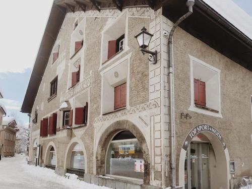 a building with an archway on the side of it at Apartment Euforia in Samedan