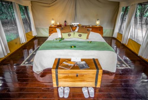 A bed or beds in a room at Karen Blixen Camp Masai Mara