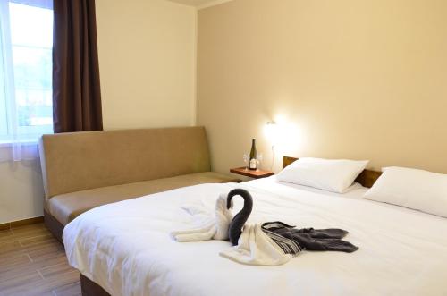 ein Hotelzimmer mit 2 Betten und Handtüchern darauf in der Unterkunft Penzion Tramín in Valtice