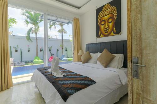 sypialnia z dużym łóżkiem i dużym oknem w obiekcie Margarita Surf Hostel w mieście Canggu