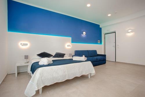 a bedroom with a bed and a blue wall at Collatina Suites in Rome