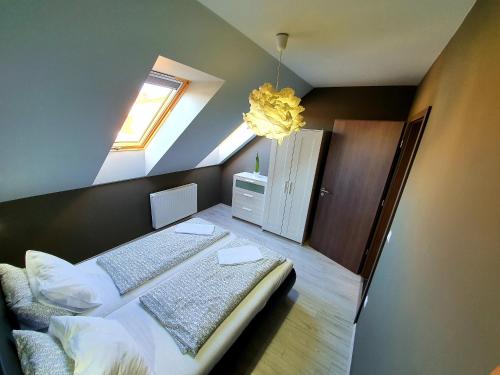 um quarto com uma cama e uma clarabóia em INTRO Apartman em Sárvár