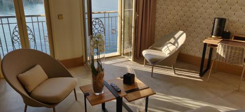 a living room filled with furniture and a dog at Splendid Hôtel in Bandol