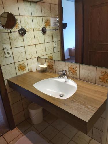 a bathroom with a sink and a mirror at Gästehaus Gitti Dorner in Hittisau