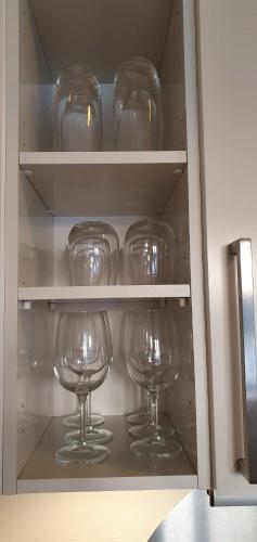 a row of wine glasses sitting in a cabinet at Harbour Penthouse in Sønderborg