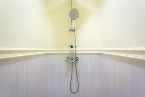 a shower in a white wall with a shower head at Summer HuaHin Condominium in Hua Hin