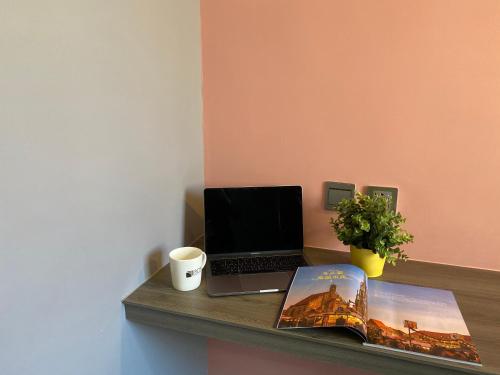 a laptop computer sitting on a counter with a book at Taichung Box Design Hotels in Taichung
