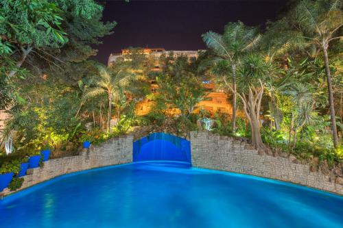 a swimming pool in a resort at night at Marina Bay in Tangier