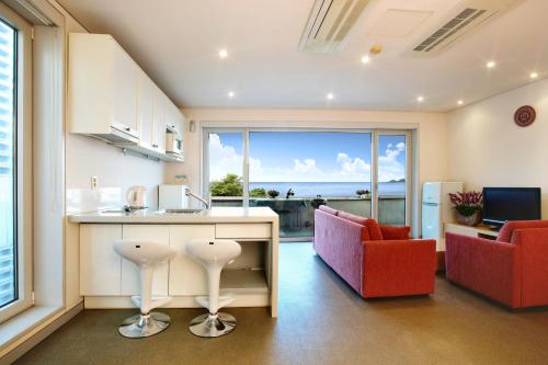 a kitchen with a view of the ocean at Tropical Dream Spa Resort in Geoje 