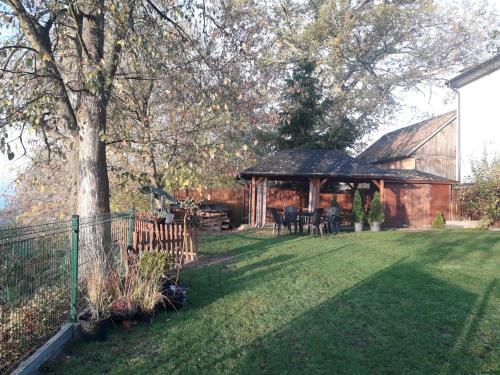 a backyard with a gazebo and a tree at Willa Amber Zakościele in Inowłódz