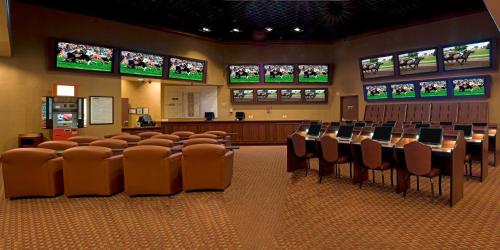 a conference room with tables and chairs and televisions at Pahrump Nugget Hotel & Casino in Pahrump