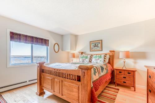 a bedroom with a wooden bed and a window at Squaw Village Condo in Greenville