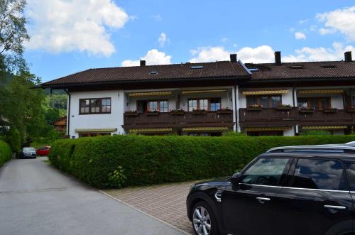 a black car parked in front of a house at Apartment 10 an der Rottach in Rottach-Egern