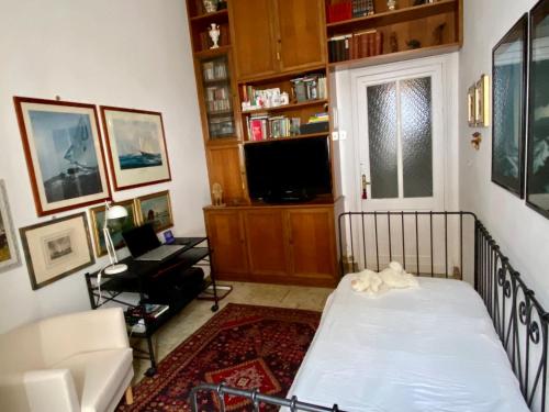 a living room with a bed and a tv at lungomare portoturistico in Chiavari