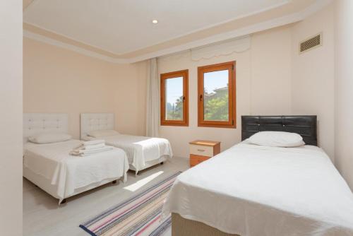 a bedroom with two beds and a window at Villa Atlantis in Dalyan
