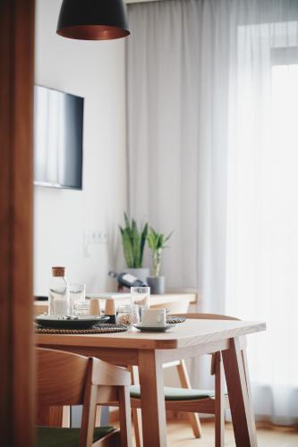 a dining room table with chairs and a table and aendant light at Quartier am Bauernstadl in Feldbach