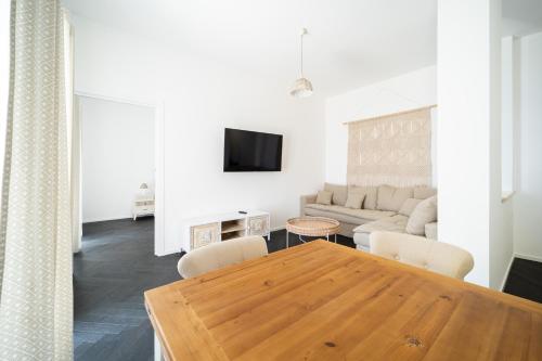a living room with a wooden table and a couch at Villa le Fontanelle in Gasperina
