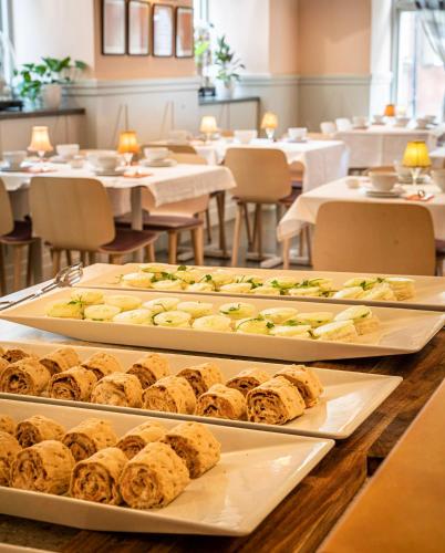 a buffet with several trays of food on a table at Lady Hamilton Hotel in Stockholm