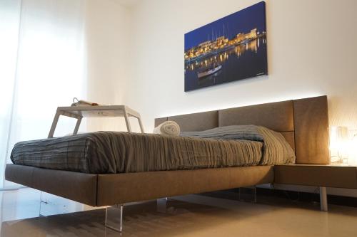 a bed in a room with a tv on the wall at Room 56 - Le Dimore in Bari