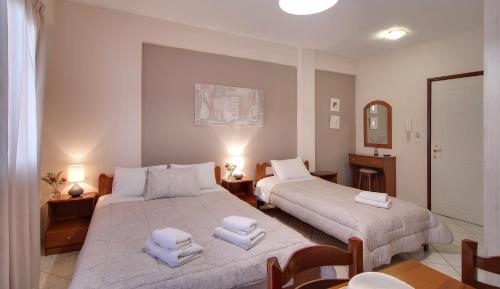 a hotel room with two beds and two lamps at Tsironis Guesthouse in Ioannina