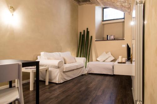 a living room with two beds and a couch at la casa del vicolo - city center - in Perugia