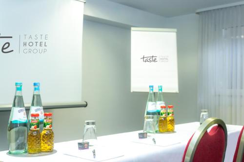 a group of bottles on a table in a room at Taste Smart Hotel Lampertheim in Lampertheim