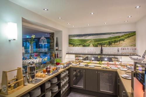 a buffet line in a restaurant with food at Hotel Im Schulhaus in Lorch am Rhein