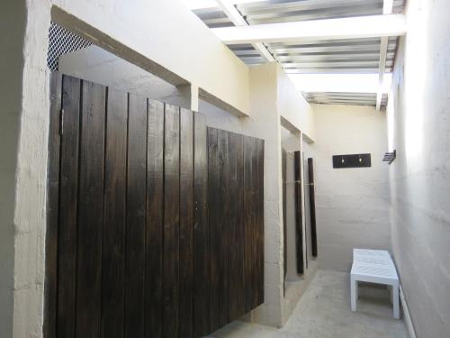 a wooden door in a hallway with a bench at Riverside Manor in Nottingham Road