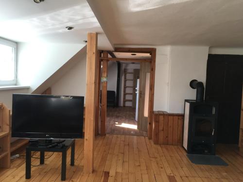 a living room with a television and a staircase at Apartment Liberec Stříbrný Kopec in Liberec