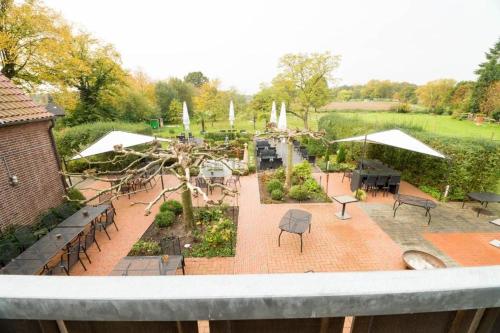 a view of a garden with tables and chairs at Haus Mühlenbrock in Schermbeck