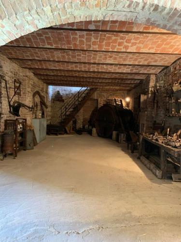 a large room with a brick wall and a staircase at THE BERGHOUSE - LA CASA SUL CLIVO with JACUZZI in Bergamasco
