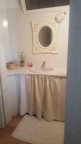 a bathroom with a sink and a mirror at THE BERGHOUSE - LA CASA SUL CLIVO with JACUZZI in Bergamasco