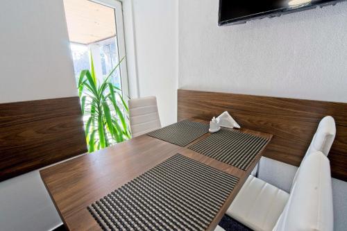 a dining room with a wooden table and chairs at AV Penzion in Olomouc