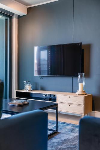 a living room with a tv and a table at Latitude Aparthotel by Totalstay in Cape Town