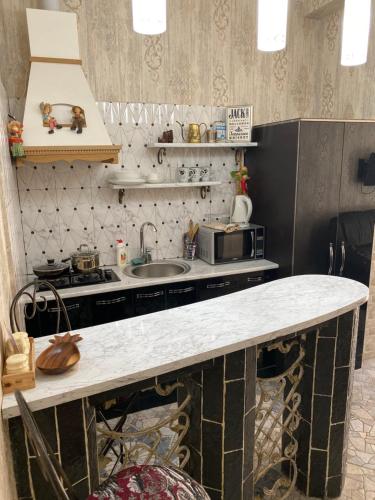 a kitchen with a counter top and a sink at Old Tbilisi Apart-Hotel in Tbilisi City