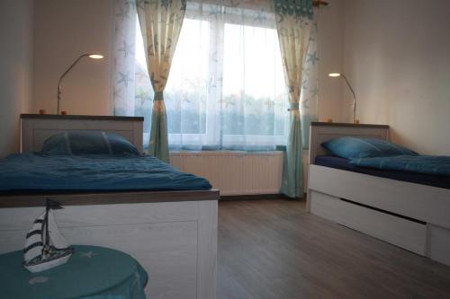 Postel nebo postele na pokoji v ubytování Ferienwohnungen Mühlenblick, 45217