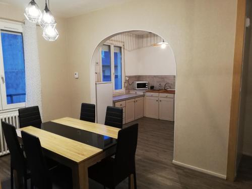 een keuken en eetkamer met een tafel en stoelen bij appartement avec 2 chambres, proche de la gare de saint brieuc in Saint-Brieuc