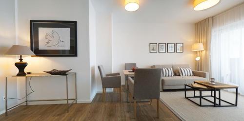 a living room with a couch and a table at Appartementhotel Fidelio in Bad Füssing