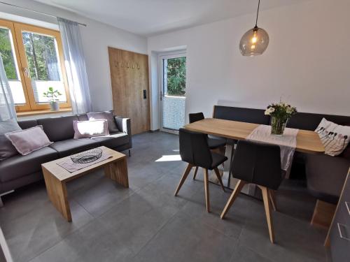 uma sala de estar com uma mesa e um sofá em Ferienwohnung Hirscher em Annaberg im Lammertal