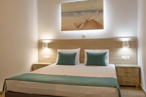 a bedroom with a large bed with blue pillows at Villa Ourania in Ierissos