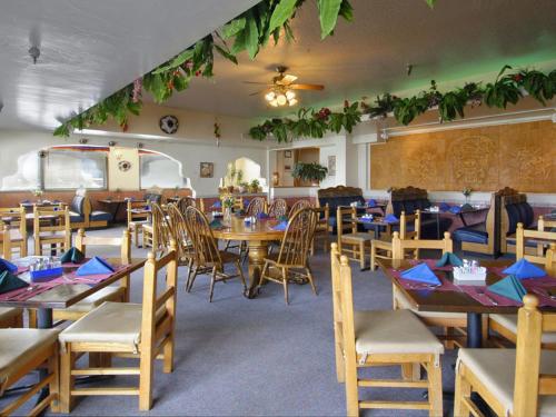 a dining room with wooden tables and chairs at Travelodge by Wyndham Juneau in Mendenhaven