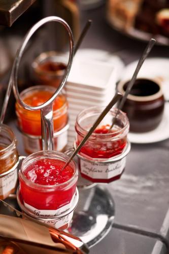 a group of small jars of jam on a table at Qubus Hotel Kraków in Kraków