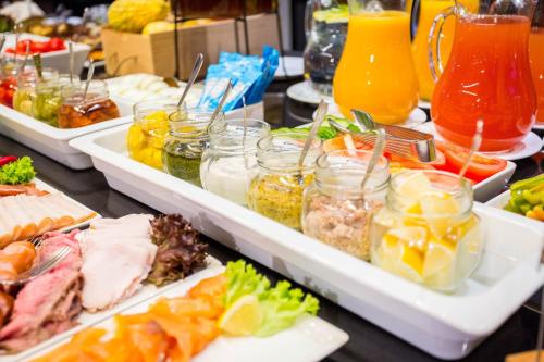 a buffet filled with different types of food and drinks at Qubus Hotel Kraków in Kraków