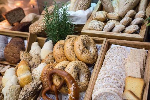 a display of different types of bread and pastries at Qubus Hotel Kraków in Kraków