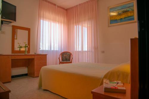 Ένα ή περισσότερα κρεβάτια σε δωμάτιο στο Hotel Califfo