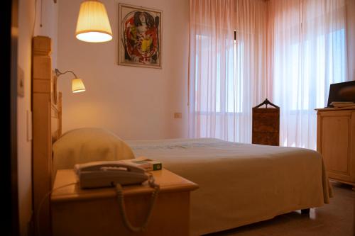 Ένα ή περισσότερα κρεβάτια σε δωμάτιο στο Hotel Califfo