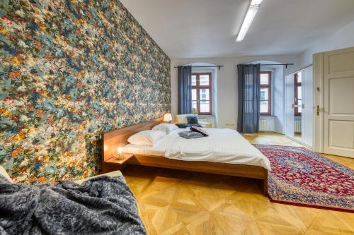 a bedroom with a large floral wall mural at CityLife Residence in Bratislava