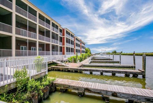 an exterior view of a building with a body of water at Water Street Hotel & Marina, Ascend Hotel Collection in Apalachicola
